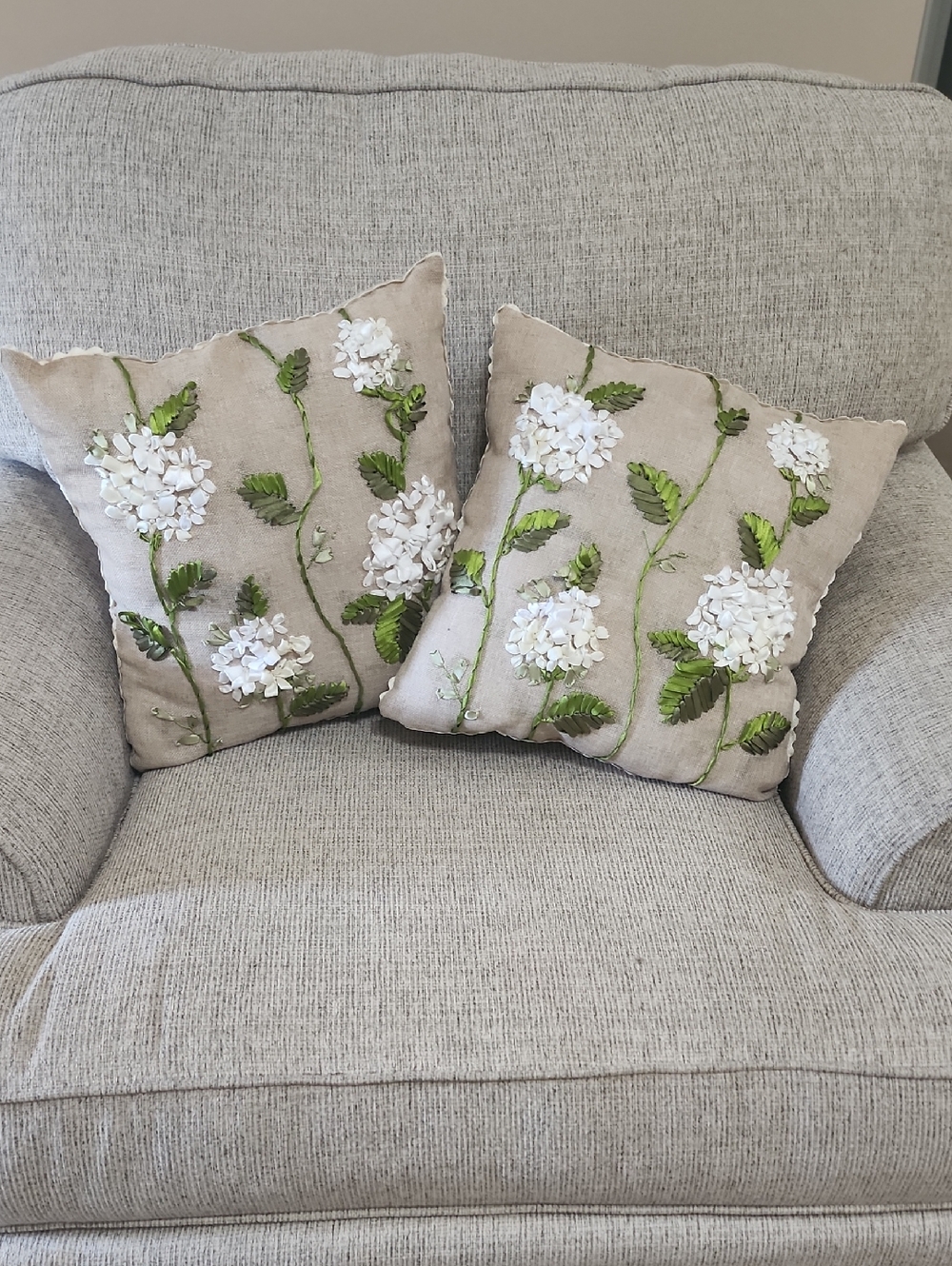 Kirklands Beige Accent Pillow Pair with White Floral Embroidery and Green Leaves